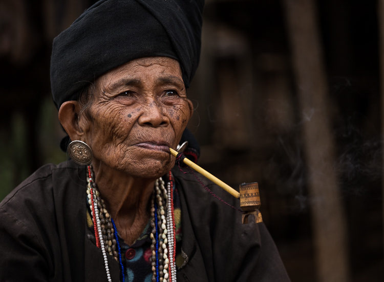 Portrait of an elderly Burmese woman smoking
