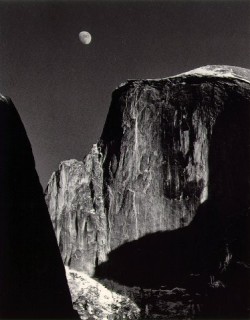 Moon and Half Dome by Ansel Adams is a renowned black and white photograph capturing the majestic Half Dome in Yosemite National Park, with a waxing gibbous moon rising above its sheer granite face