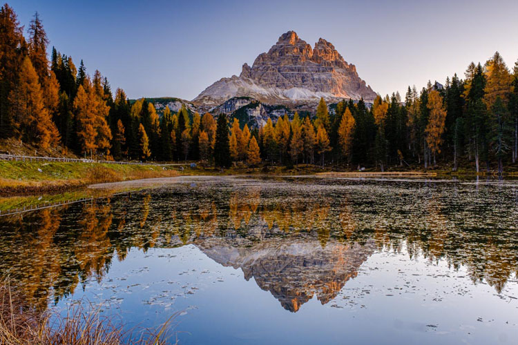 low camera angle captures the reflection in the still water