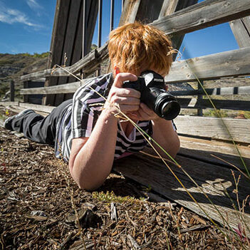 Woman learning some photography basics about using her camera at a workshop