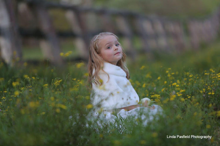 young model poses for her portrait photo while sitting with the flowers