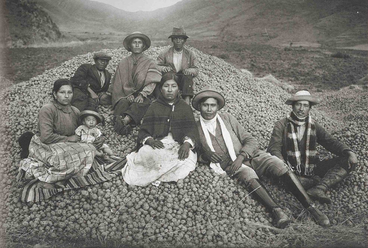 A typical scene seen in Peru, of a family of potato famers with their harvest taken by Martin Chambi