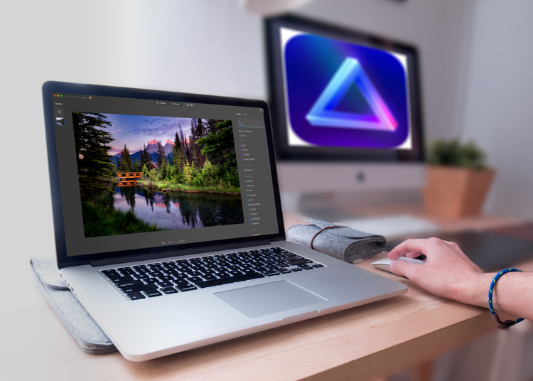 Mac laptop with a landscape photo on it
