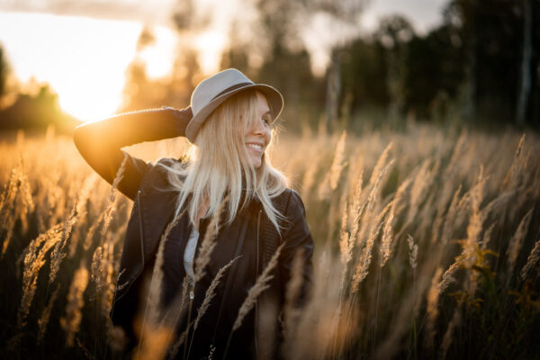 woman in field at sunset before bokeh applied to photo