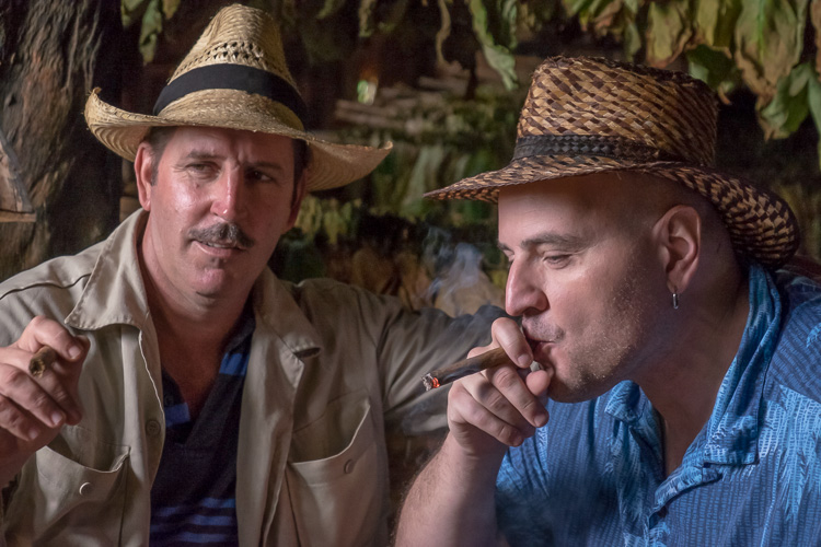 Two men smoke cigars in Cuba with shadows processed out