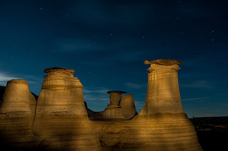 Photo of the hoodoos in Drumheller Alberta at night by student Karen Albert