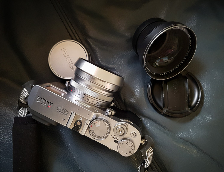 fuji x100f review product shot showing camera, lens and lens cap from above