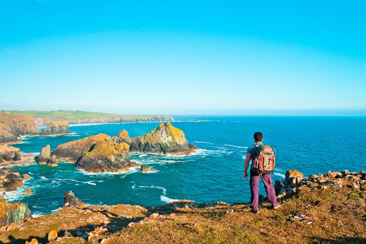 landscape photography checklist photographer with backpack on a hilltop