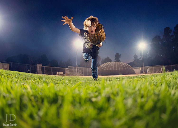 an action shot of my kid diving for a baseball