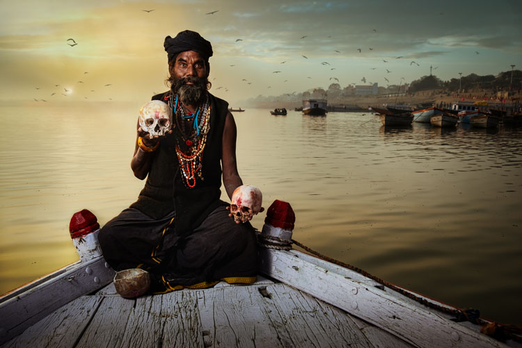 An Aghori Sadhu on boat after sky replacement done with Luminar Neo