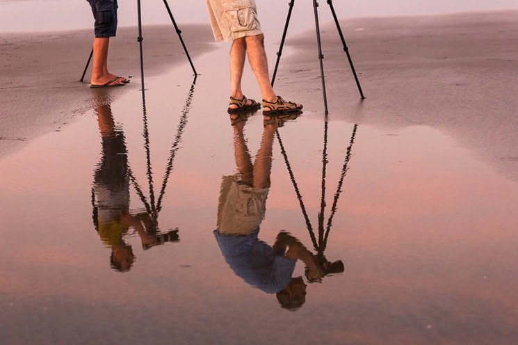 Tripod Reflection on the Beach Reflection of two photographers using tripods on the beach