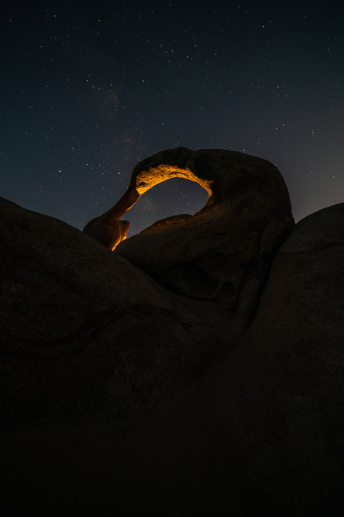 light painting Mobius arch with Milky Way clearly visible in the sky behind