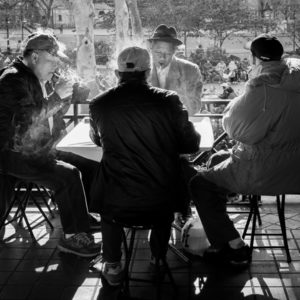 Street photography shot of men sitting at a table