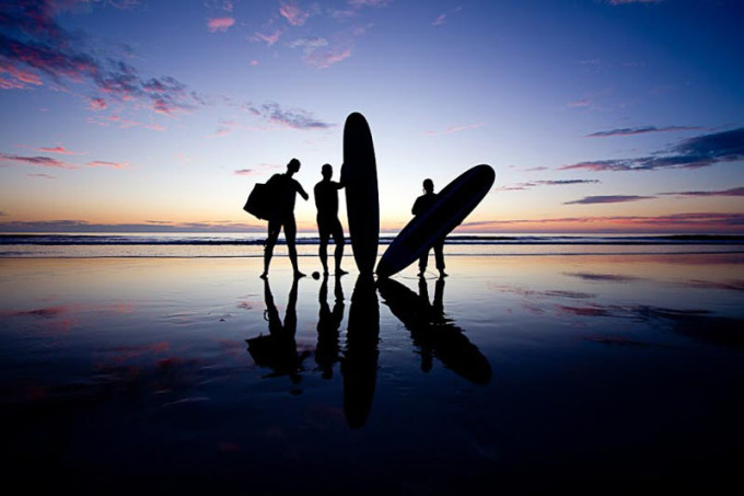 surfers with surf boards in silhouette
