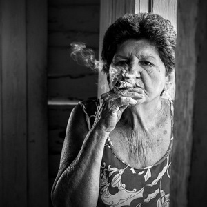Travel photography - woman smoking a cigar in Cuba