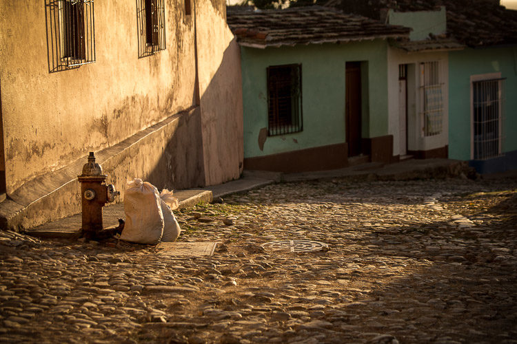 This is a spot I found at sunset in Trinidad Cuba. It's got gorgeous light, sweeping across the cobble stones. It just felt a bit empty to me. So I waited.