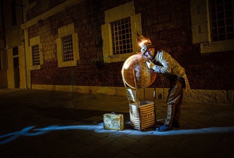 night photography light painting using a flashlight for the effect at Venice Carnival