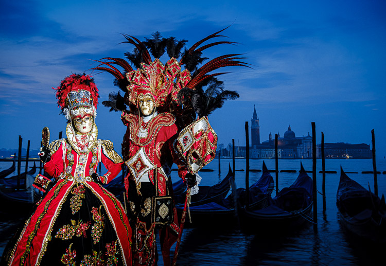 costumes at carnival lit with flash during blue hour