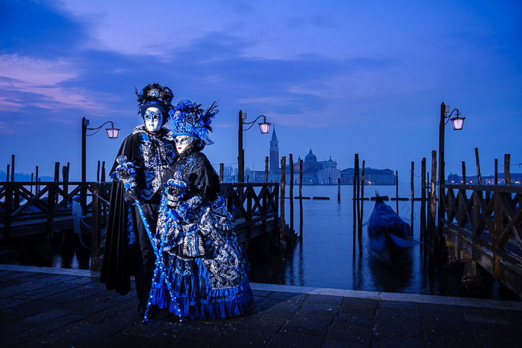 off camera flash used in this photo of Venice carnival costumed characters and lamps made to look lit with photo editing software Lightroom