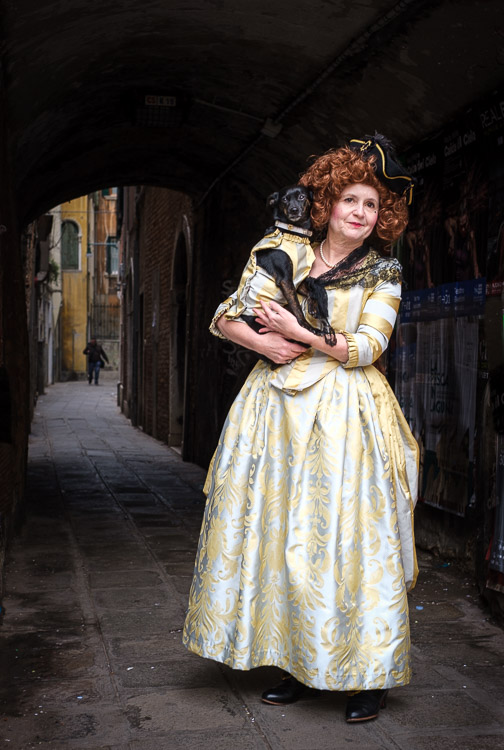 Dog and owner in historical costumes on the streets of Venice