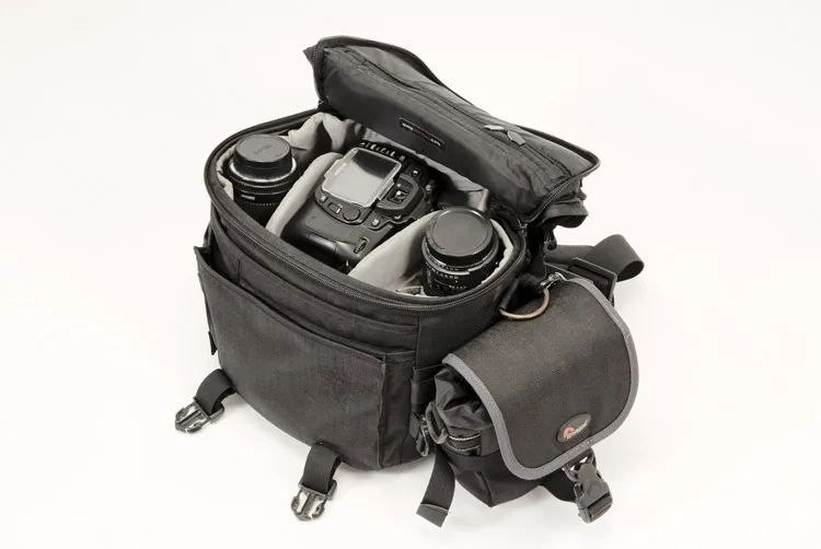 a common style of camera bag with a zip open top and a shoulder strap