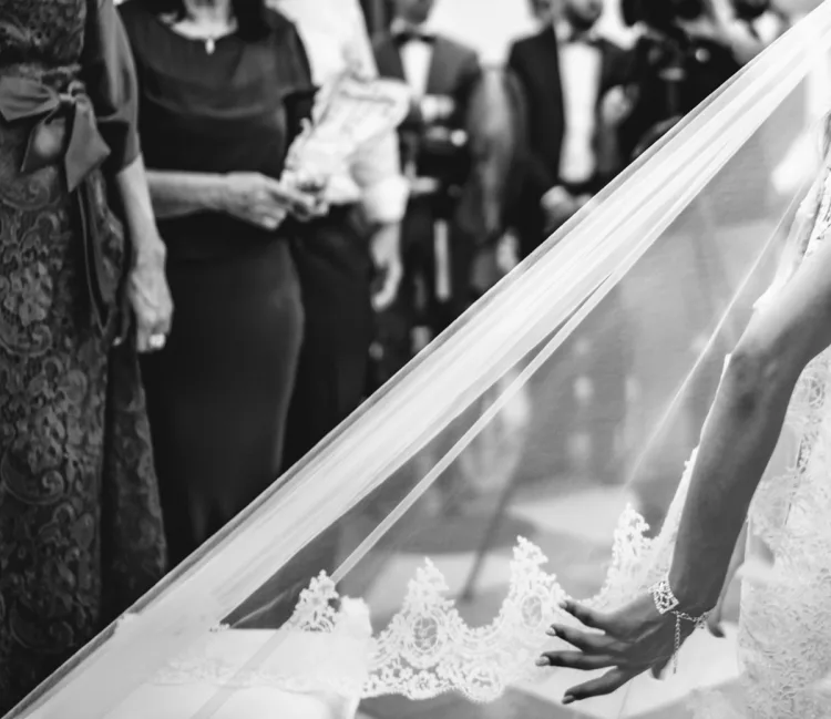 black and white tones of a wedding veil and brides hand